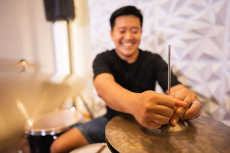 selective focus of a drummers hand setting up hi-hat clutch cymbals before useの写真素材