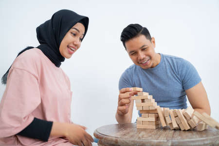 Man knocks down wooden blocks that have been arrangedの写真素材