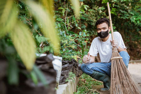 young volunteers keep the environment clean by picking up trashの写真素材