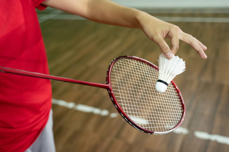 Close up of badminton players hand holding racket and shuttlecockの写真素材