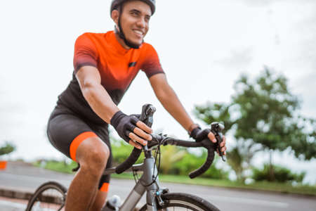male cyclist with hand on a handle bar close upの写真素材