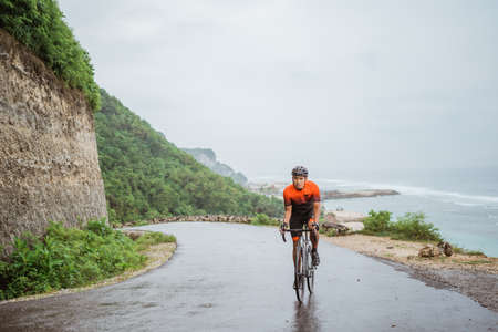 road bike cyclist riding his bike on a cliffの写真素材