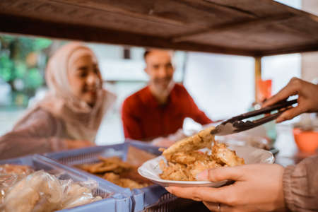 muslim couple ordering food to break fasting in ramadanの写真素材