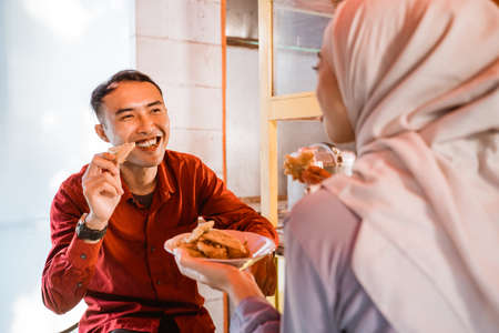 muslim couple sitting on traditional food stall, waiting for iftar timeの写真素材