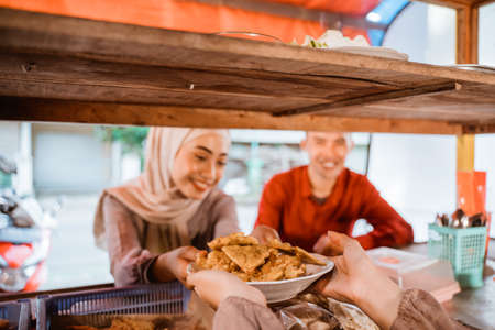 muslim couple ordering food to break fasting in ramadanの写真素材