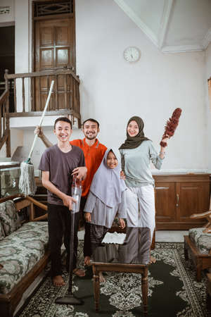 Father, mother and two children smiling cleanly togetherの写真素材