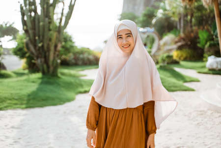 attractive muslim asian woman wearing scarf outdoorの写真素材