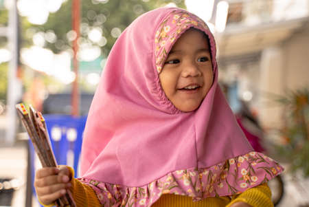 adorable muslim young kid with headscarf smilingの写真素材