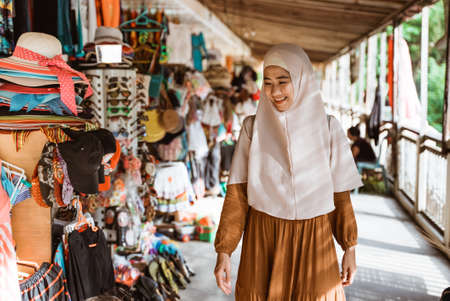 beautiful muslim asian woman wearing scarf walkingの写真素材