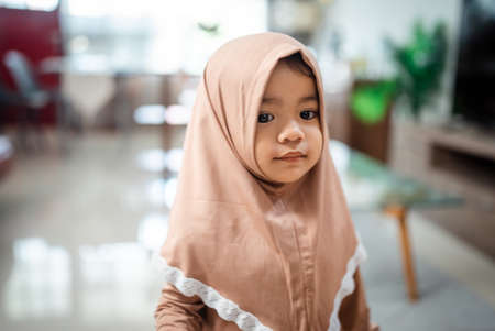 Cute Muslim toddler girl ini hijab at homeの写真素材