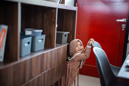 Cute Muslim toddler girl ini hijab at home