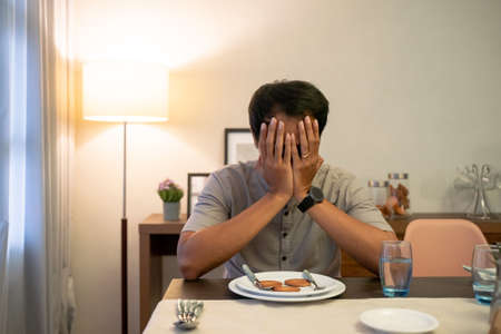 impatient muslim male waiting to break his fastの写真素材