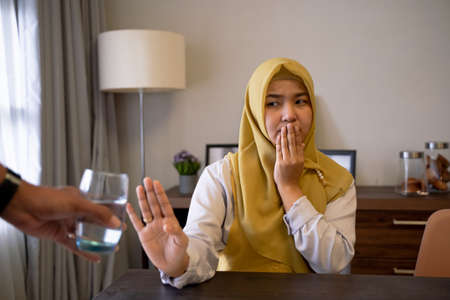 muslim woman refuse the offer to drink waterの写真素材
