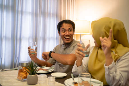 excited couple having iftar dinner time togetherの写真素材