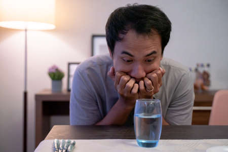 impatient muslim male waiting to break his fast and drinkの写真素材