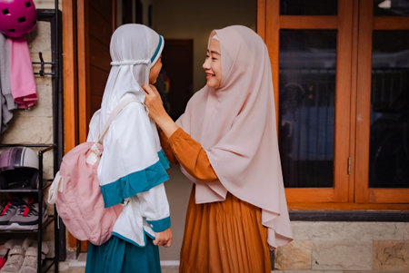 adorable young mother and daughter preparing for school