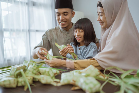 muslim asian family making ketupat for eid mubarak together