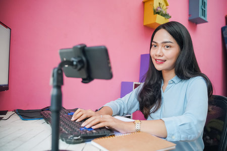 Freelance asian woman working using phone from home