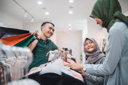 muslim family shopping together at the mall buying some new clothesの写真素材