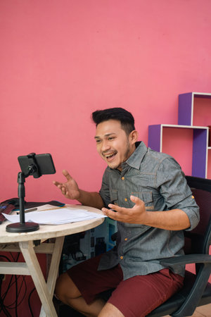 Freelance asian man using phone meeting from home