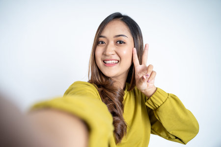 close up of young woman selfie with v sign