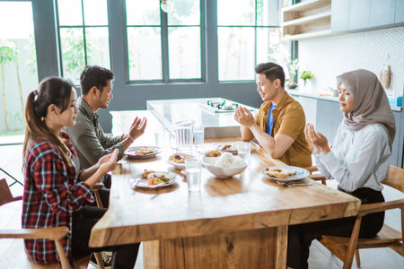 asian young people eating lunch together in the kitchen