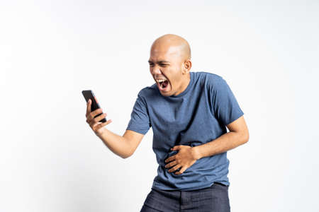 happy asian bald man looking at a mobile phoneの写真素材