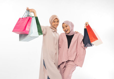 muslim bestfriend happy holding a shopping bag over white background