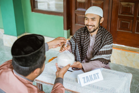man giving a rice as a food donation for zakat during eid mubarak