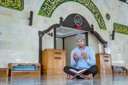 Man muslim doing prayer in the mosque and reading quran