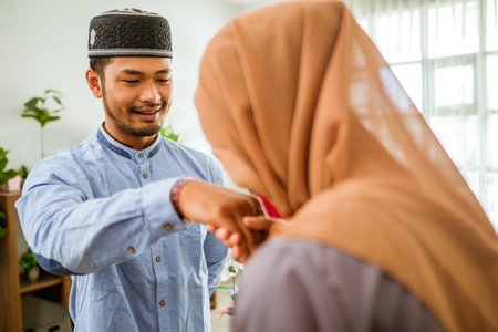 muslim woman shake hand and kiss her husbands hand