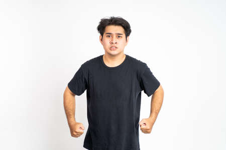 angry young man looking forward to cameraの写真素材