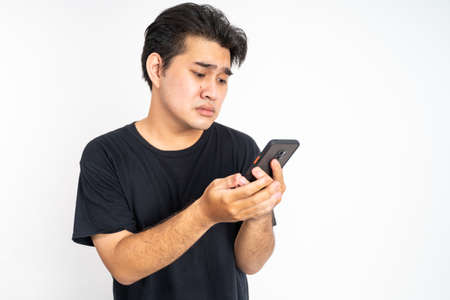 worried young man getting bad news from social mediaの写真素材