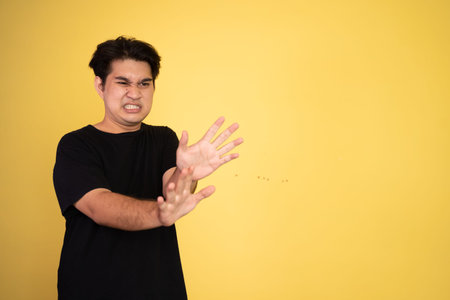 oung man rejecting offer with both palms on isolated background