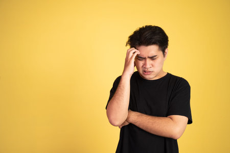 unsure asian young man wearing black shirt