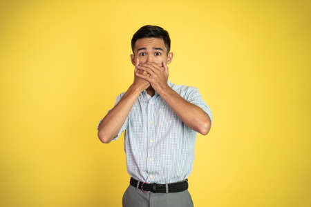 portrait of a man with hands covering mouthの写真素材