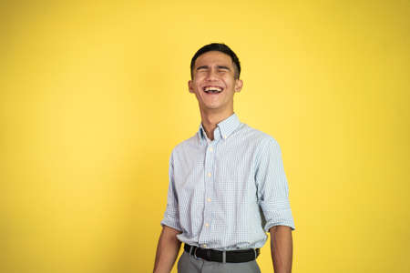 asian businessman laughing naturally over isolated backgroundの写真素材