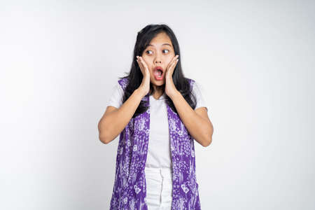 portrait of young asian woman feeling shocked and suprised over isolated backgroundの写真素材