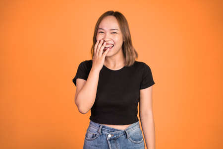 happy asian woman laughing out loud. excited beautiful woman feeling joy on isolated backgroundの写真素材
