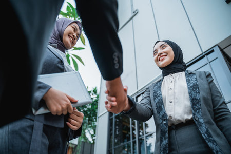 muslim business partner shaking hand at the office front during first meeting