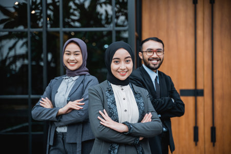 beautiful muslim businesswoman leader as she standing in front of her team smiling proudly to camera