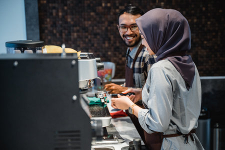 two happy asian cafe worker at the coffee preparing to make coffeeの写真素材