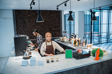 muslim waitress or owner and partner portrait smiling to camera at the coffee shop
