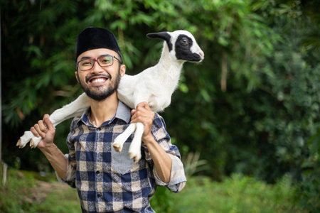 farm animal trade for eid adha sacrifice. man farmer and seller of goat and cow checking his goatの写真素材