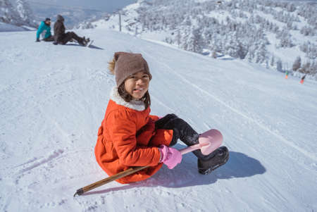 happy little girl playing outside in the snowの写真素材