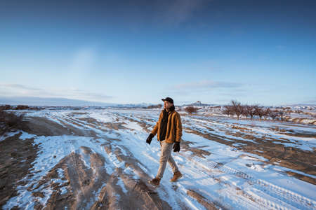 portrait of asian man hiking on beautiful natural landscape in cappadocia turkeyの写真素材