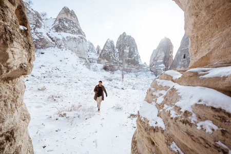 portrait of asian man hiking on beautiful natural landscape in cappadocia turkeyの写真素材