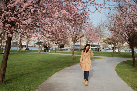 beautiful portrait of beautiful woman enjoy cherry blossom in the parkの写真素材