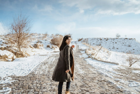 portrait of young happy attractive woman in snowy cappadocia