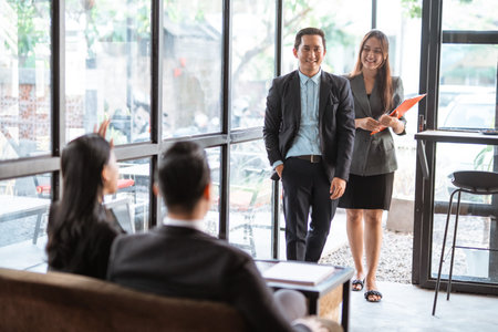 asian young worker while meeting in cafe with partner and assistant